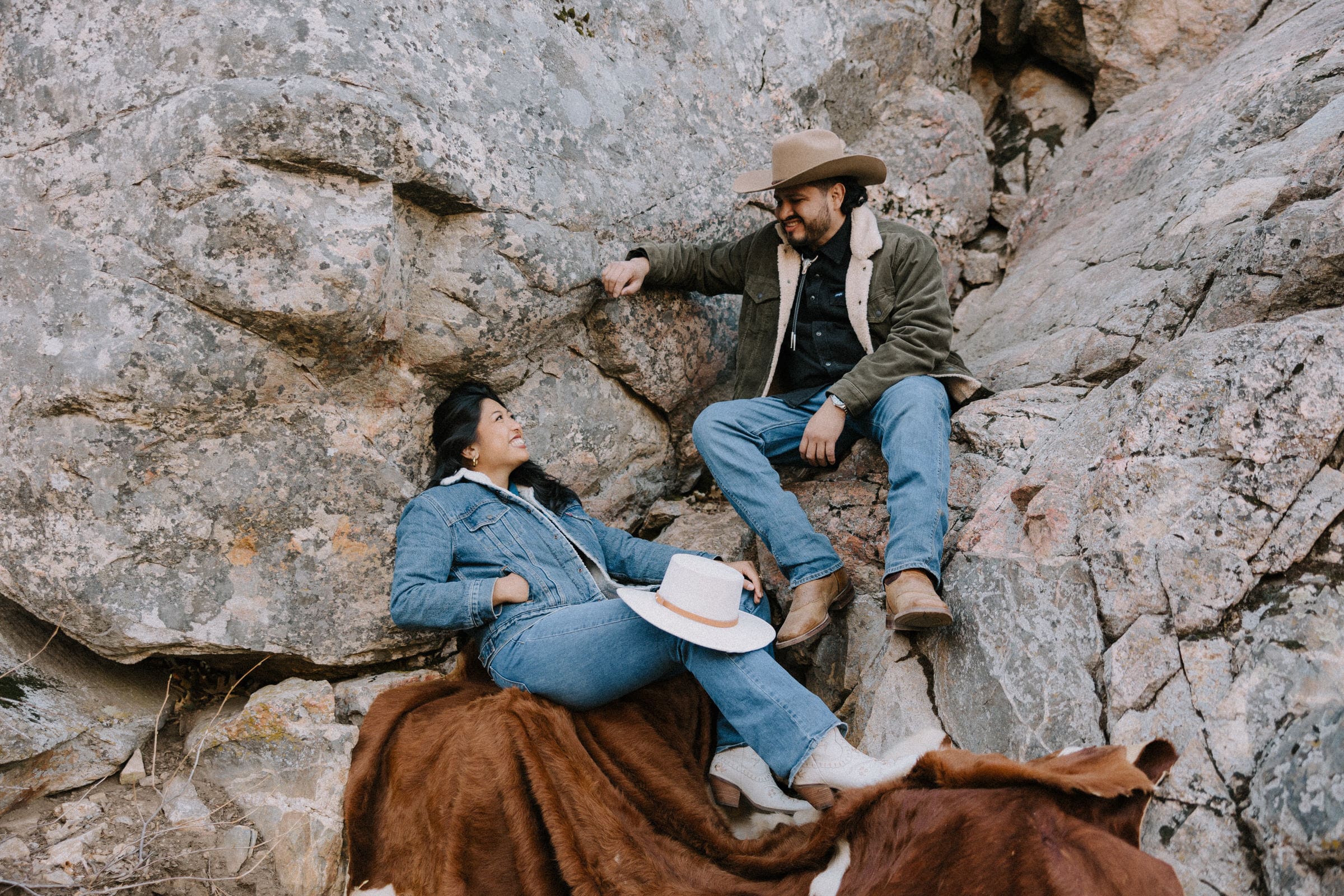 Jenna and Armando wearing Western-themed attire during their timeless engagement session in the Lake Arrowhead forest.