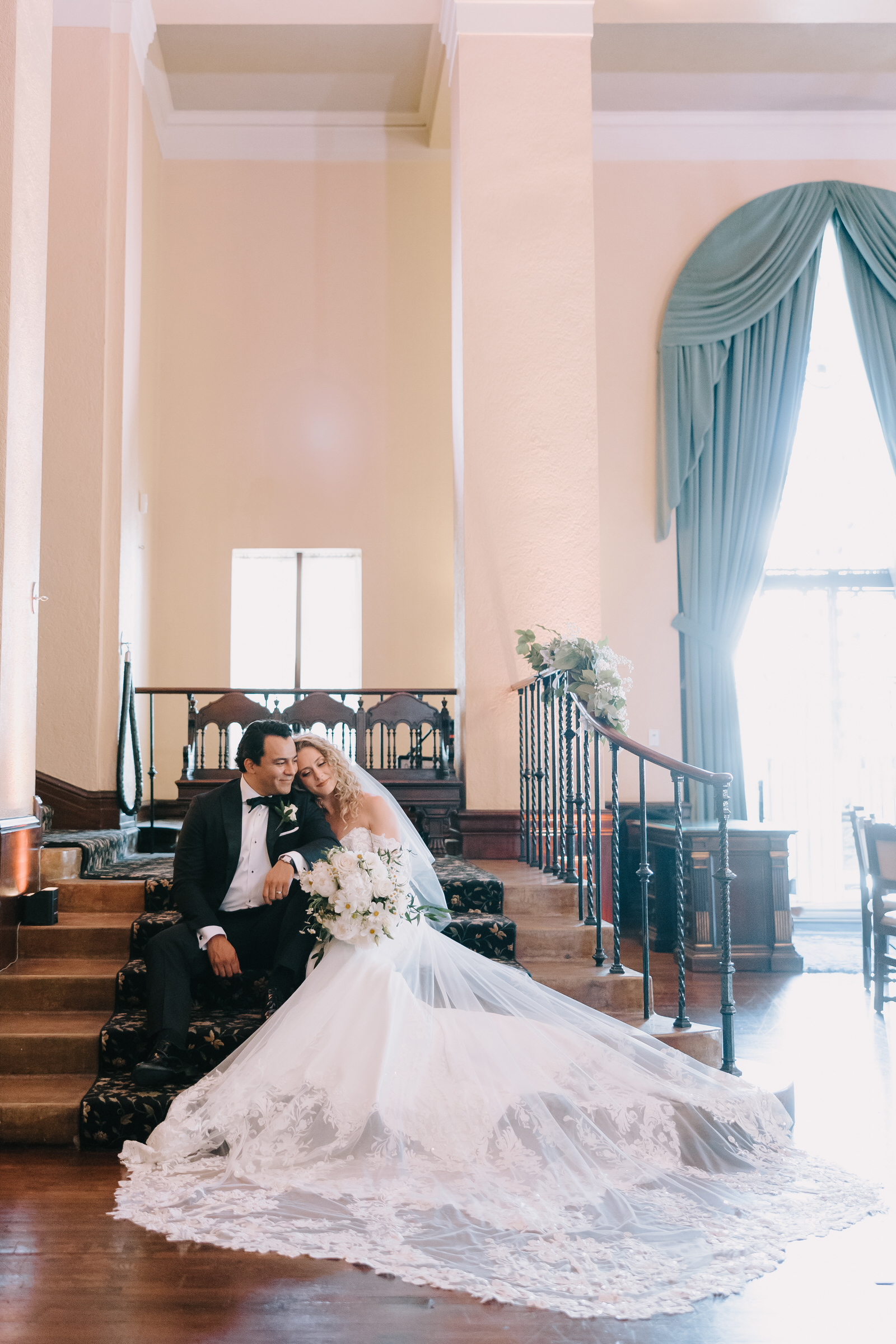 Katie and Mark sharing a cinematic moment under the dramatic arches of The Ebell of Los Angeles.