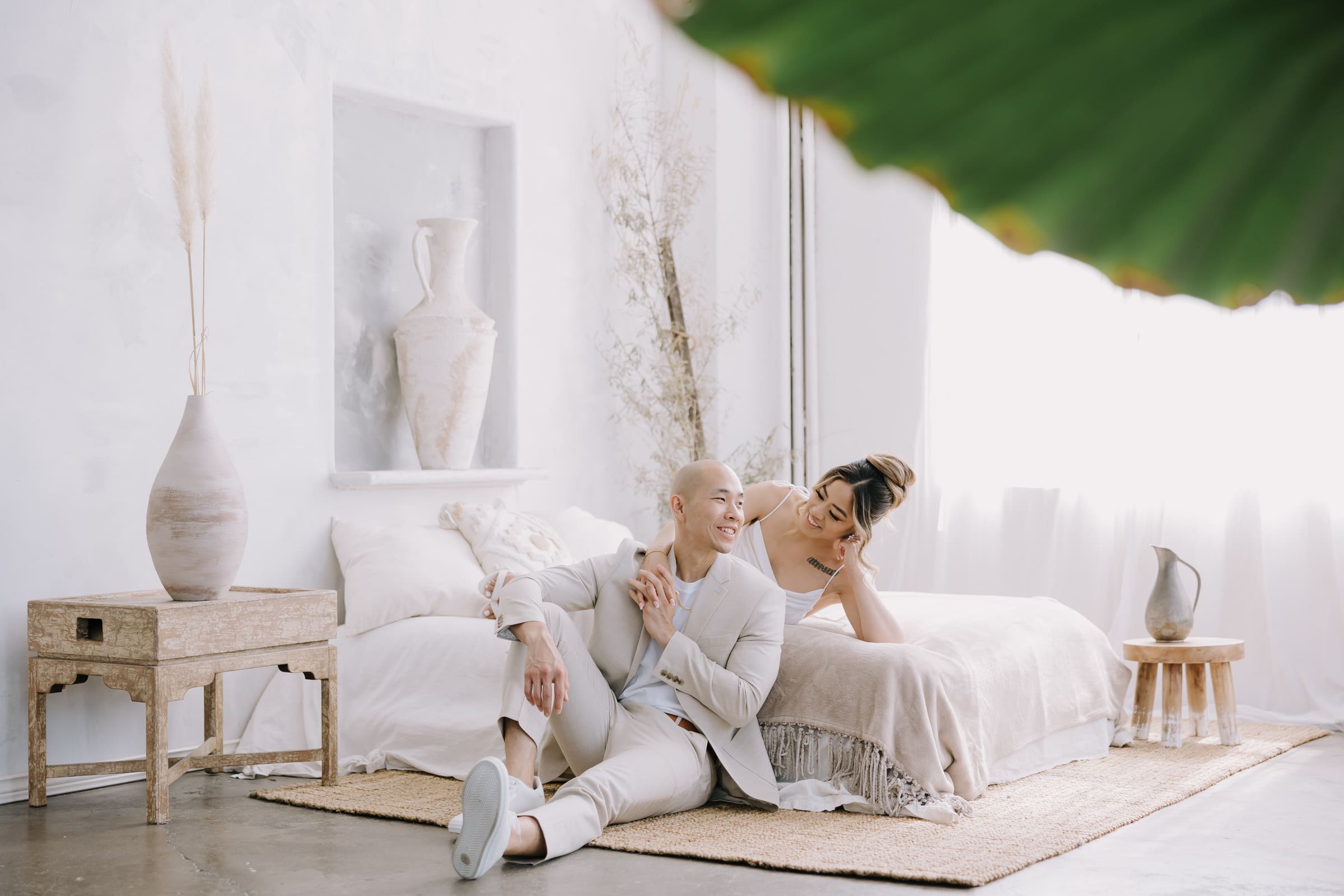 A boho-inspired DTLA loft engagement session featuring natural light and rattan decor.