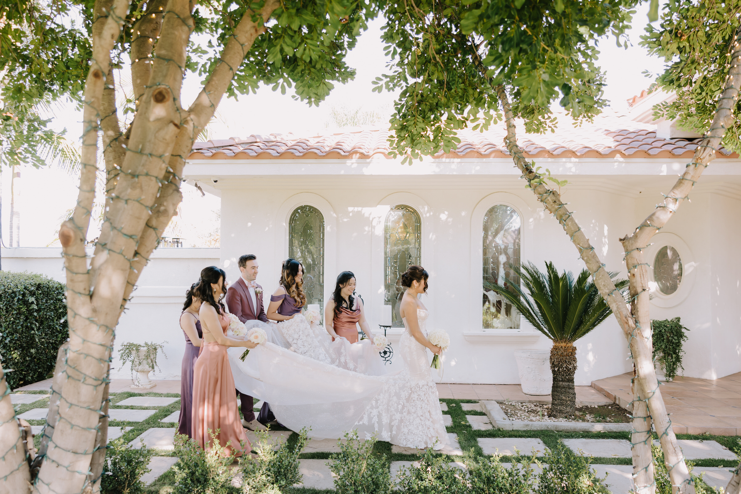 Celestine and Cameron walking through the lush vineyards at Villa de Amore during sunset.