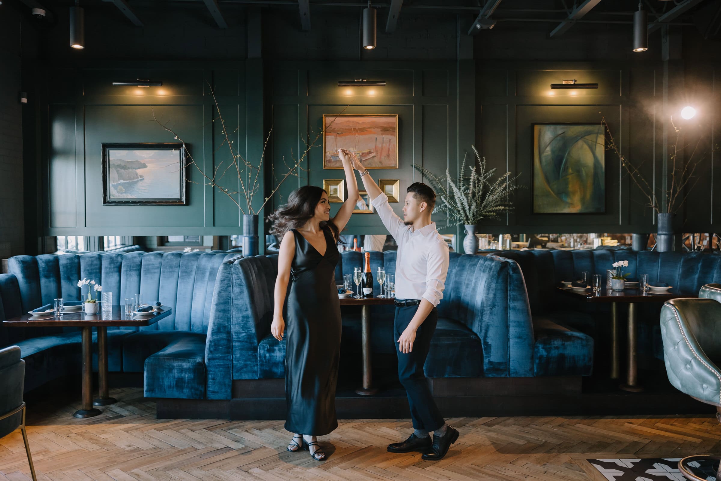 A couple enjoying a nostalgic engagement session inside CdM Restaurant.