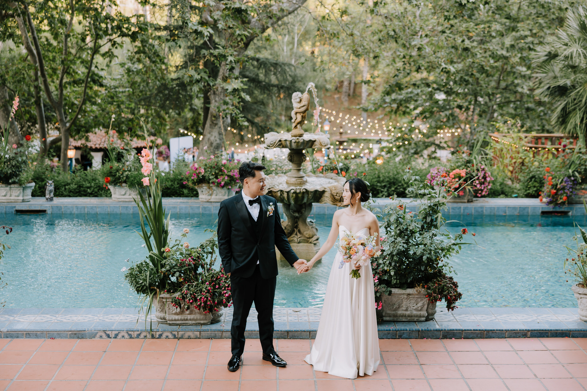 Donna and Keitaro standing in front of the hand-painted tiles at El Teatro within Rancho Las Lomas.