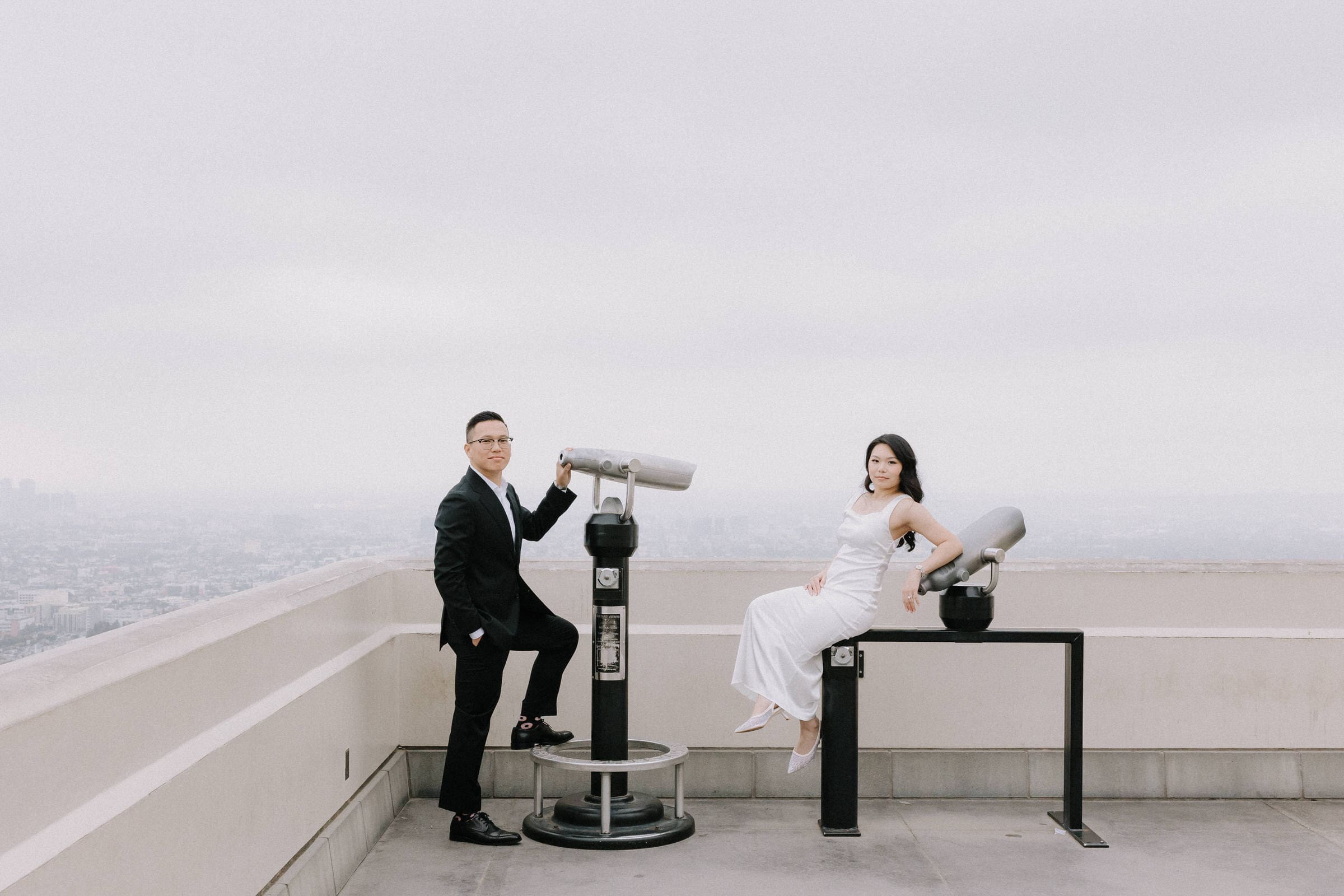 Allan and Kat embracing at Griffith Observatory with the Los Angeles skyline in the background.