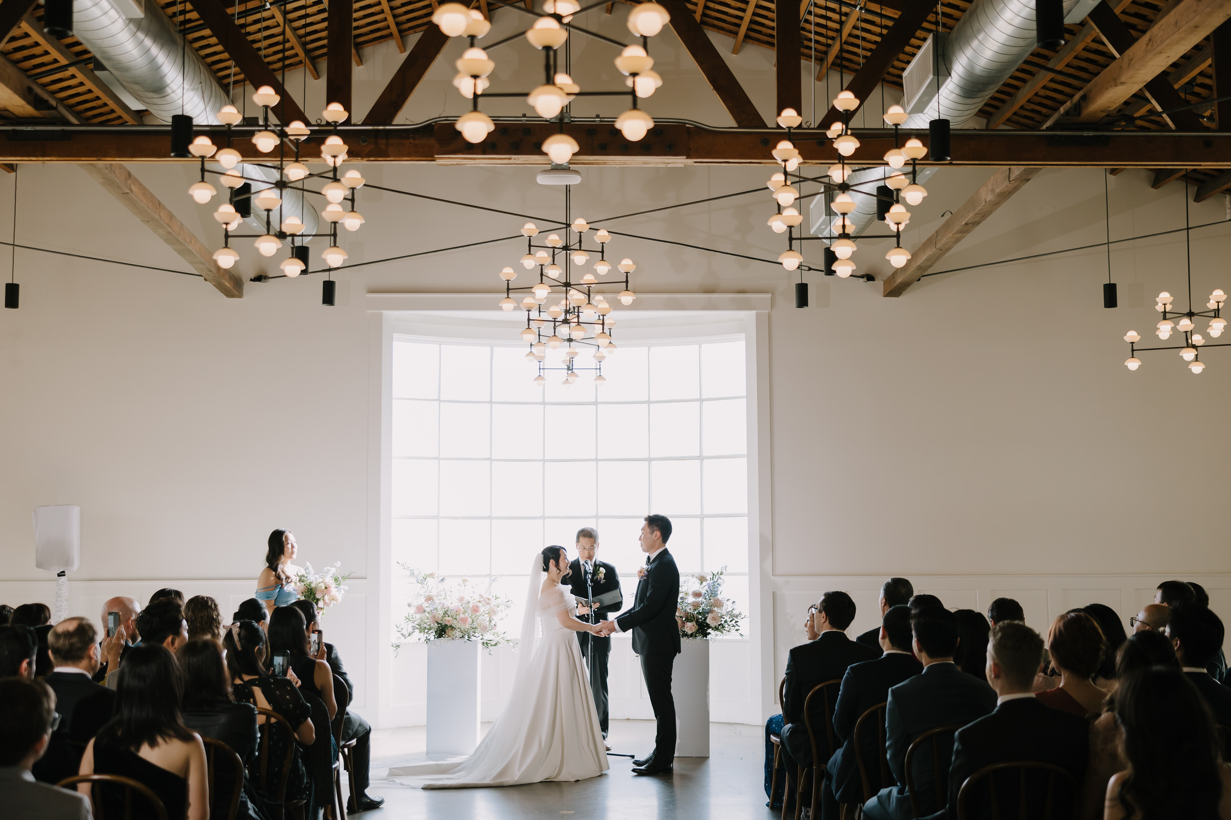 Jing and Bailey laughing inside a vintage trolley during their wedding portrait session in Old Town Orange.