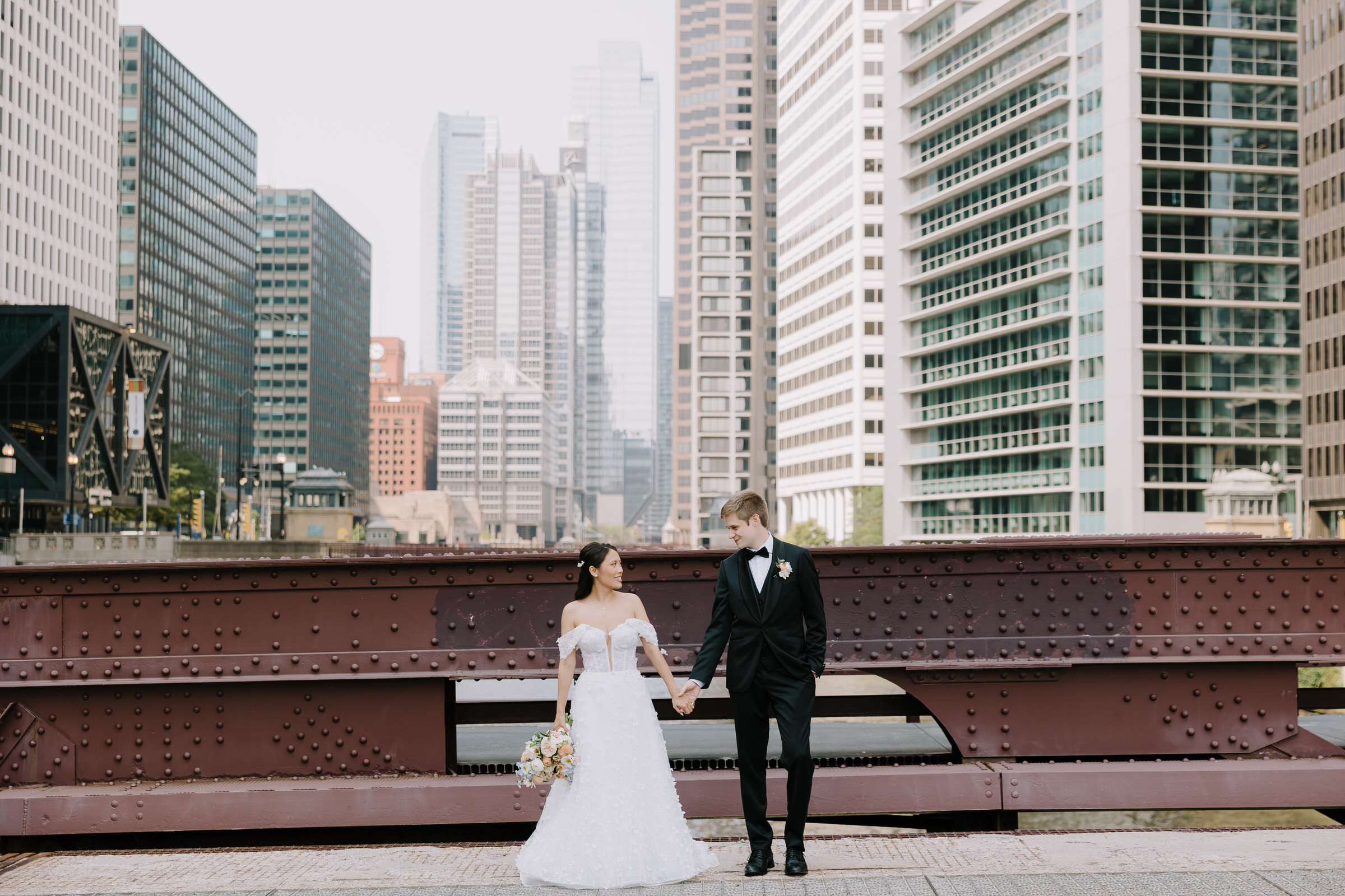 Lily and Craig sharing a stylish moment against the large industrial windows and exposed brick of The Walden in Chicago.