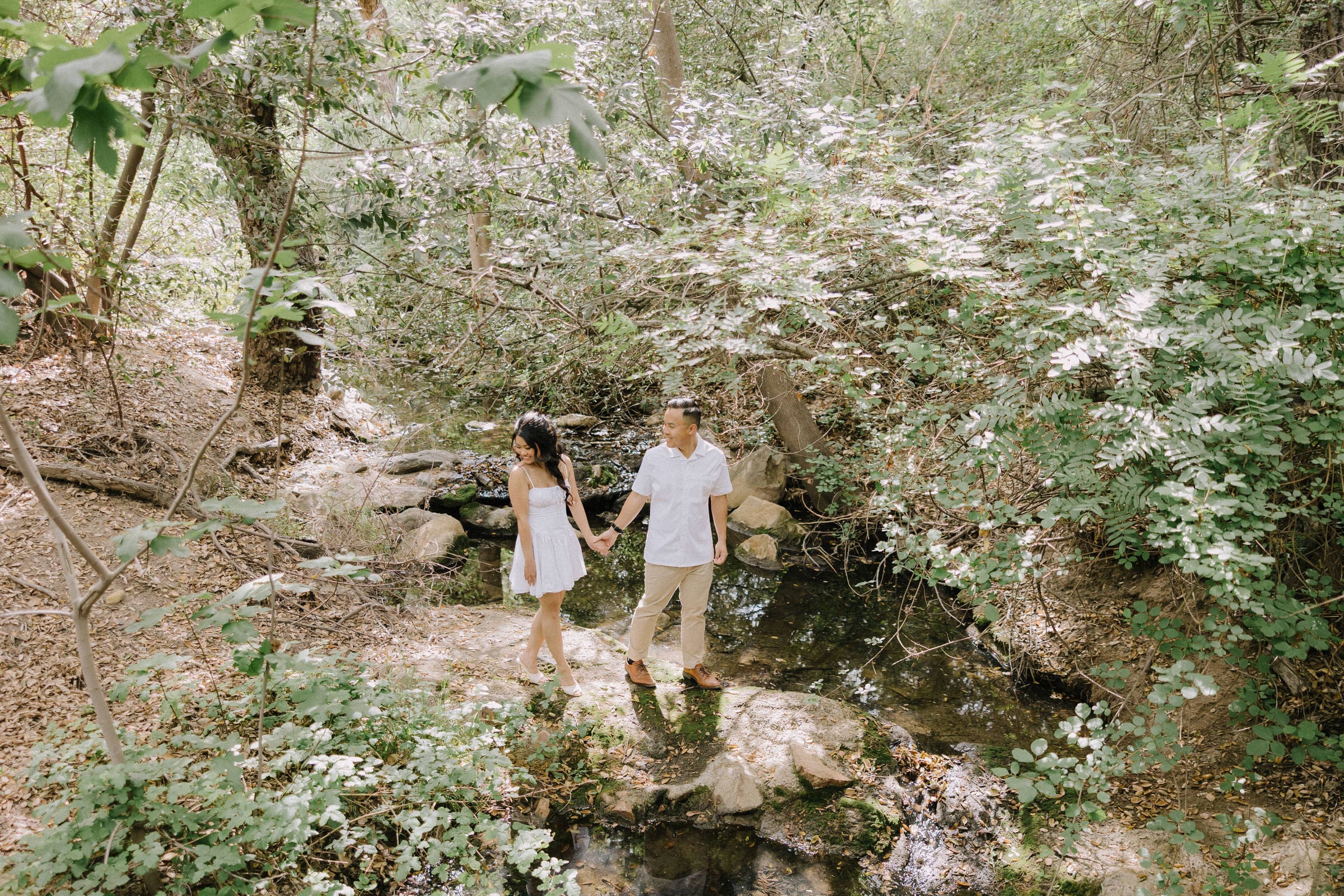 Maddy and Matt walking along the tide pools at Treasure Island Beach in Laguna Beach during sunset.