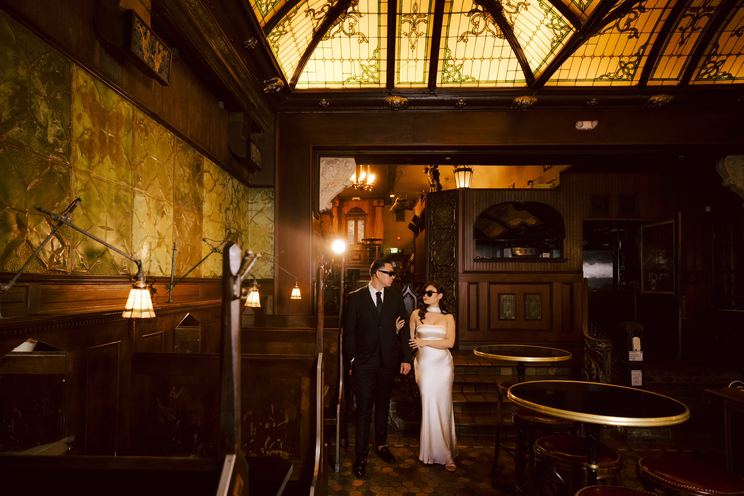 A stylish couple enjoying cocktails during their engagement session at The Wolves in Downtown Los Angeles.
