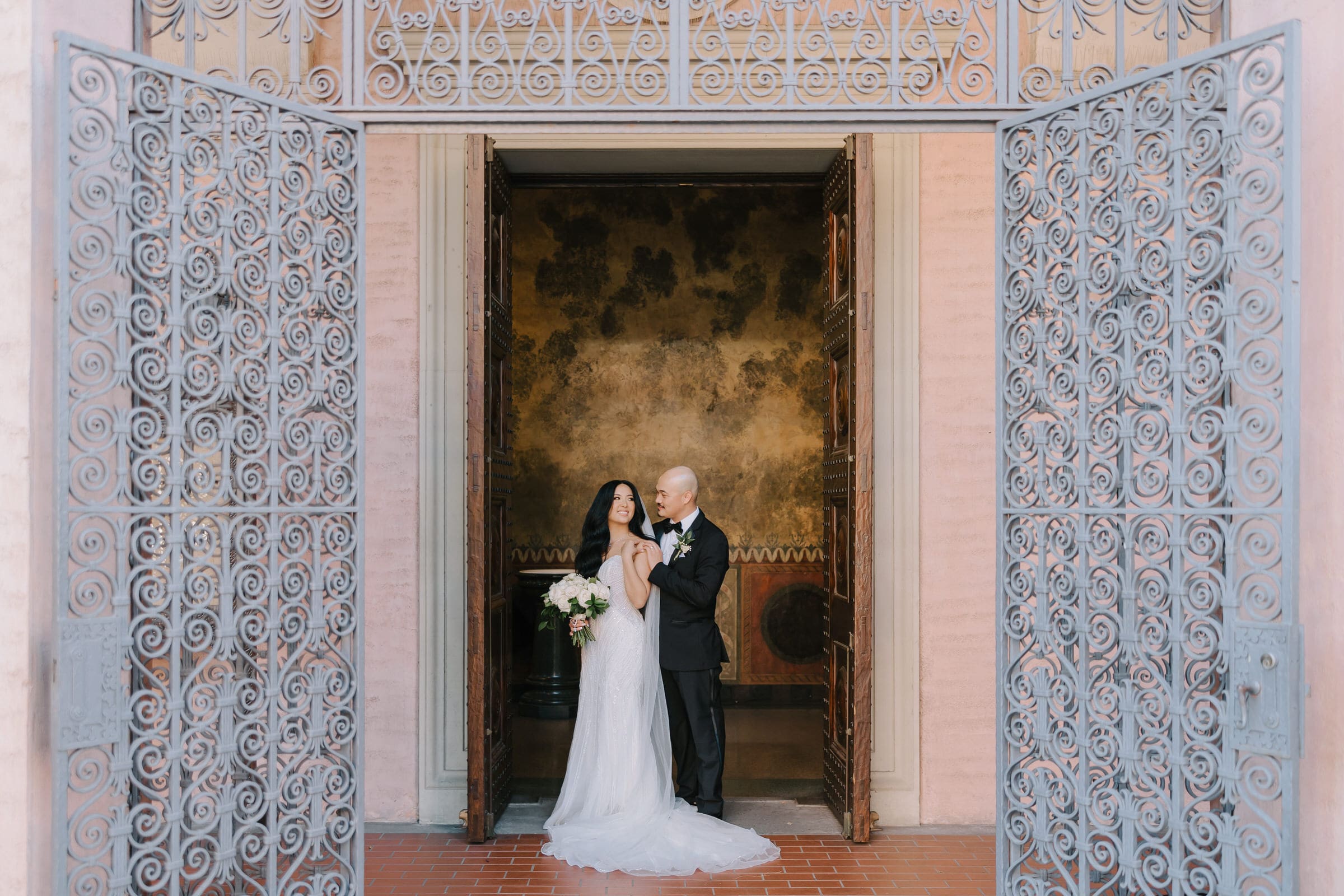 Smush Wille-Anne and Matt standing under the ornate arches of St. Andrew's Church in Pasadena.