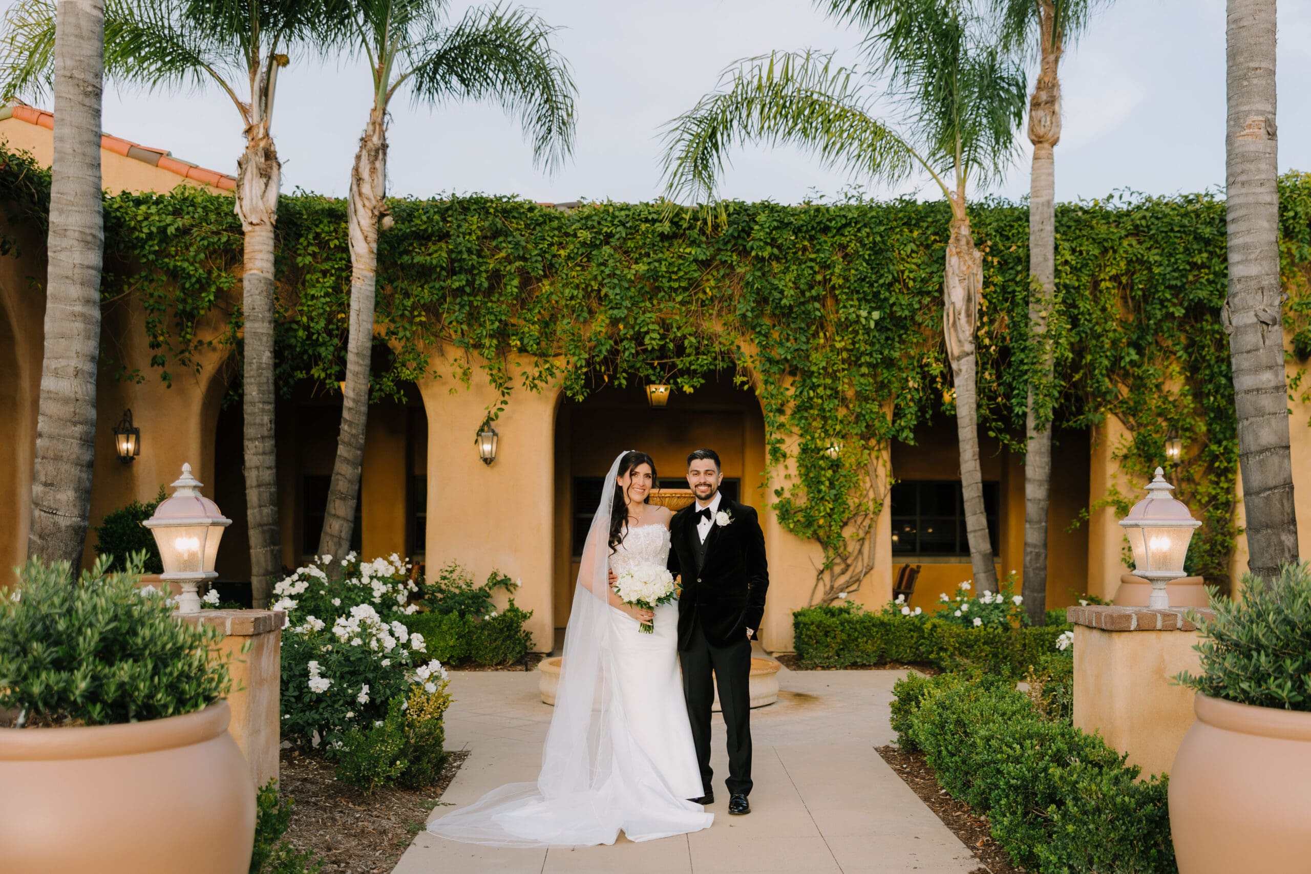 Bride and groom smiling at their Tuscan-style wedding venue, The Retreat by Wedgewood Weddings in Corona, California.
