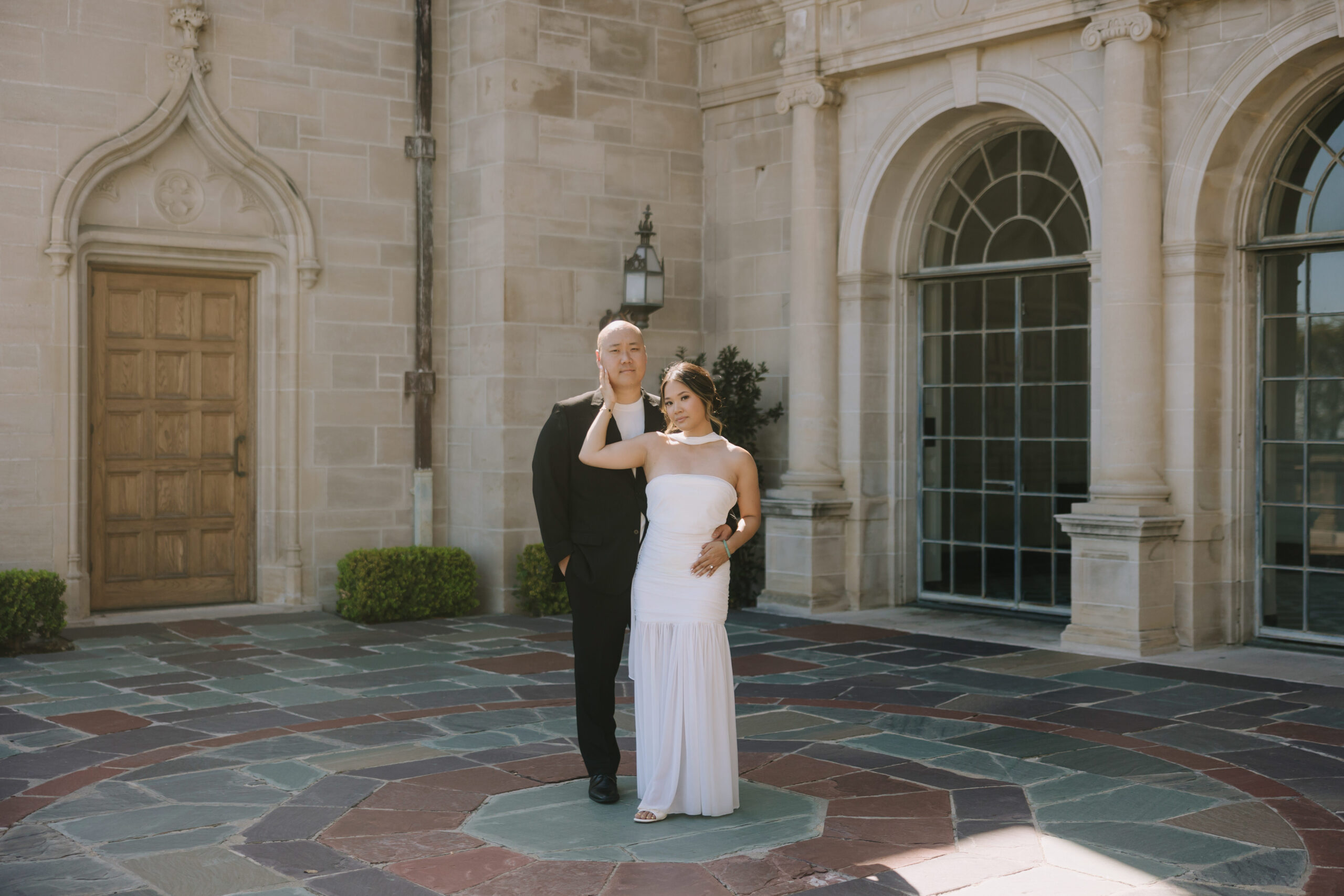 Juli and Paul posing outside Greystone Mansion in Beverly Hills during their high-fashion engagement photo session.